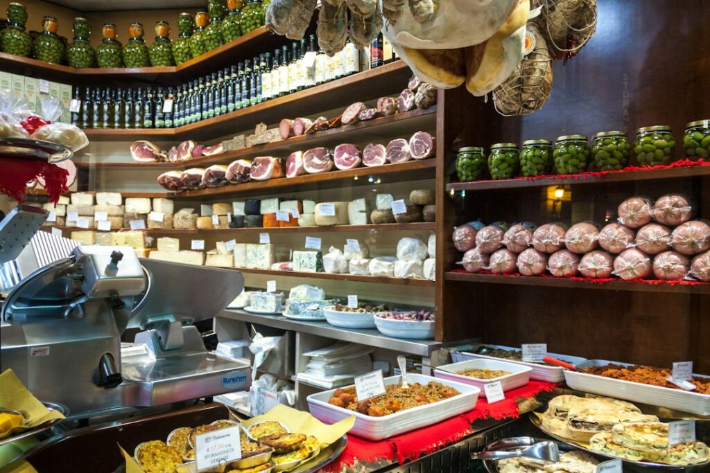 Deli counter filled with cheeses, meats, and prepared foods